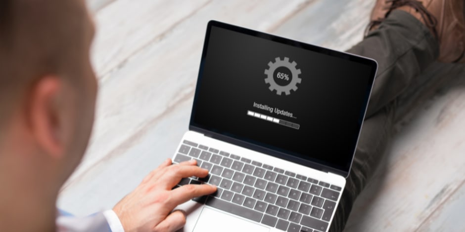 Laptop screen reading "Installing Updates" for Awin's new available platform features